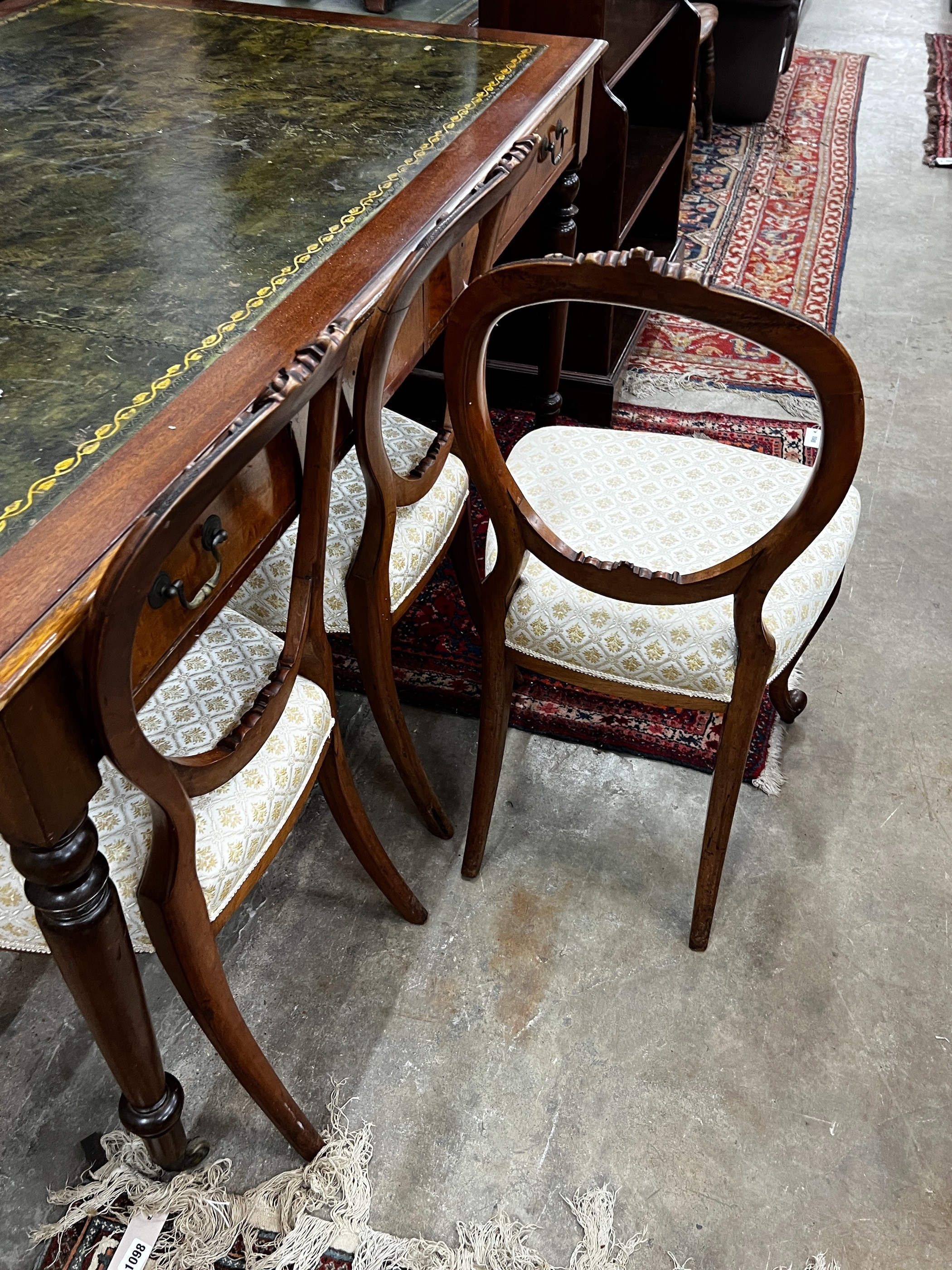 A set of six Victorian walnut balloon back dining chairs